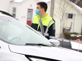 A paramedic responds to a three-vehicle crash at Lake and MacDonald in Sault Ste. Marie, Ont., on Wednesday, Dec. 23, 2020. (BRIAN KELLY/THE SAULT STAR/POSTMEDIA NETWORK)