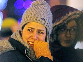 A mourner is seen at a candlelight vigil outside the Alberta legislature on Wednesday, Jan. 8 in memory of the victims of the Ukraine International Airlines crash in Tehran, Iran. Among the 176 people killed when the airliner was shot down last month were 57 Canadian citizens. A total of 138 people on the flight were connecting to Canada via Kyiv. Larry Wong/Postmedia Network