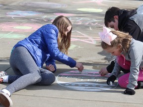 Amid the pandemic, Kaelyn, 12, and Natalie Cooper, 5, along with Carter Heykants, 12, filled their driveway with chalk drawings to help spread the message of positivity to their neighbours in the Summerwood neighbourhood on Sunday, March 22. Lindsay Morey/News Staff