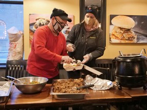 Leo and Rhonda Ford volunteered at the Flippin' Bosses Christmas Eve event in Tillsonburg. Organized by Mike Jourdy of Flippin' Mike's and Melodie Boyle of Boss Leaf, more than 200 Christmas dinners were handed out and delivered along with hundreds of toys. (Chris Abbott/Norfolk and Tillsonburg News)