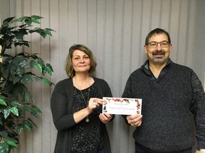 Stan Burkholder and Pauline Lyman (Chamber manager) hold the cheque for chamber change.