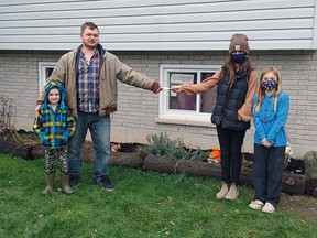 Johnny Hall, 6, and his dad Joe received a cheque from Shana and Danica McKillop on Dec. 13, 2020. The McKillop sisters and their 4H animals recently helped out with a fundraiser for the West Elgin Daffodil Auxiliary and the Dunwich United Church. The proceeds for the Daffodil Auxiliary went to the Hall family, whose son has been undergoing treatment for leukemia. (Handout/Postmedia Network)