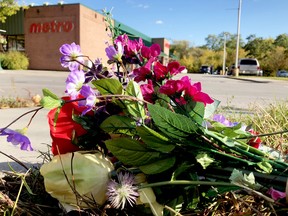 Flowers lie as a memorial near the spot where Parinaz Motahedin was killed in a collision at the intersection of King Street West and Clarissa Street. (FILE PHOTO)