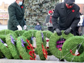 Remembrance Day service at cenotaph on Queen Street East in Sault Ste. Marie, Ont., on Wednesday, Nov. 11, 2020. Strong winds repeatedly blew over wreaths. (BRIAN KELLY/THE SAULT STAR/POSTMEDIA NETWORK)