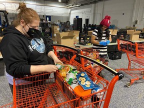 Staff at the Wood Buffalo Food Bank sort food donations from the 28th Syncrude Food Drive on November 28, 2020. Supplied Image/Wood Buffalo Food Bank