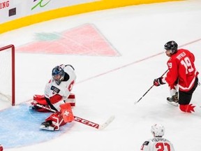 Canada's Quinton Byfield (19) scores a goal on Switzerland goalie Noah Patenaude (1) during third period IIHF World Junior Hockey Championship action in Edmonton on Tuesday, December 29, 2020.