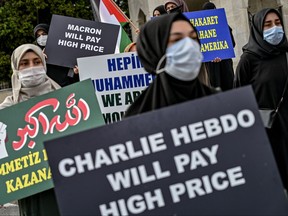 Protesters chant slogans and hold signs against France and the French President in Istanbul, on September 13, 2020, during a protest against the reprinting of the cartoon of the Prophet Mohammad by the French magazine Charlie Hebdo. - Earlier this week satirical French weekly Charlie Hebdo, the target of a massacre by Islamist gunmen in 2015, reprinted the controversial images to mark the beginning of the trial of the alleged accomplices in the attack.