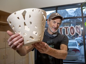 Canmore potter Joe Martin holds one of his Covid-19 themed creations at ArtsPlace where he works as a ceramics studio technician. photo by Pam Doyle/www.pamdoylephoto.com