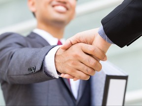 Asian businessman making handshake with smiling face