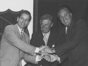 NHL commissioner John Ziegler, middle, poses with Bruce Firestone, left, representing Ottawa, and Phil Esposito, representing Tampa Bay, after those bids won NHL expansion franchises on Dec. 6, 1990.