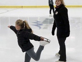 Paris Figure Skating Club coach Penny Colwell looks on as student Fiona Harwood works on an element.