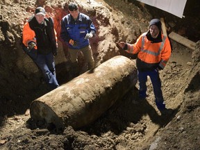 A bomb disposal team stands next to the Second World War bomb they made safe in Augsburg, southern Germany, on Dec. 25, 2016.