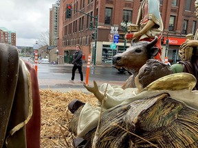 Colette Thornycroft, of Brockville, walks past the Nativity scene at the foot of Court House Avenue on Wednesday afternoon. The season of Advent began this week, meaning Christmas, albeit a different kind of Christmas, is around the corner. (RONALD ZAJAC/The Recorder and Times)