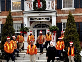 1000 Islands Gananoque Chamber of Commerce executive director Amy Kirkland stands in the forefront with the team of Hydro One employees who spent the day decorating Town Hall, the Visitor Centre and Town park.(SUBMITTED PHOTO)