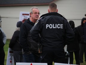 Lanark-Frontenac-Kingston MPP Randy Hillier chats with a Cornwall officer before the start of the Cornwall March for Freedom on Nov. 21 in Cornwall.