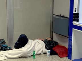 A homeless man sleeps in the ATM area of a downtown bank on Thursday night. (WAYNE LOWRIE/The Recorder and Times)