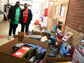 Chatham brothers Derek and Brett Gore pose for a photo with the haul of toys they donated to the Salvation Army Chatham-Kent Ministries at the Orangewood Boulevard site on Dec. 3, 2020. They purchased the toys using $5,214 they received by collecting and turning in used bottles and cans.