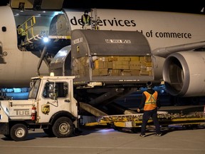 Canada's first batch of Pfizer/BioNTEch COVID-19 vaccines are unloaded from a UPS cargo plane at Montreal-Mirabel International Airport in Montreal, Quebec, Canada December 13, 2020.  Cpl Matthew Tower/Canadian Armed Forces/Handout via REUTERS.