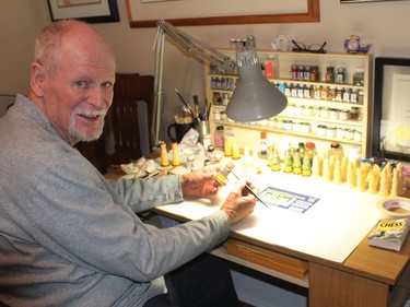 George Sims paints a chess piece he recently cast that will be added to the 60 chess sets the Chatham man has collected over the years. Ellwood Shreve/Chatham Daily News/Postmedia Network