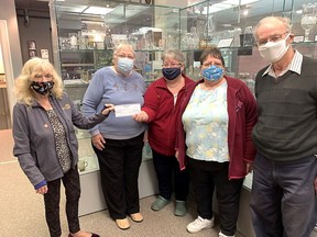 Sussan Londry, left, president of the Wallaceburg Rotary Club, hands a cheque for $10,000 to the Wallaceburg and District Museum members Elaine Gatt, museum president, treasurer Dee Gallerno and secretary Louise Benn. With them is Rotarian Herman Geithoorn. The money will help the museum install buttons that, when pushed, say what the exhibits include and are about. The donation is among several the service club is making, as it will be closing later this month. (Jake Romphf, Postmedia Network)
