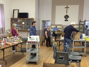 Some of the volunteers at work during a previous edition of the Lancaster Food Bank effort led by the Knights of Columbus. This year, because of the pandemic, only cash donations are being accepted.Handout//Cornwall Standard-Freeholder/Postmedia Network