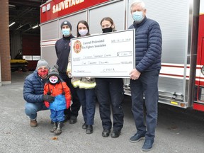 Ian and Danik Butcher, along with newly hired firefighters Rodolph Sabbak, Emily MacDonald and Briar McKay were on hand on Tuesday in order to give a $1,000 donation to Children's Treatment Centre president, Don Fairweather, courtesy of the Cornwall Professional Fire Fighters Association. Photo on Tuesday December 8, 2020 in Cornwall, Ont. Francis Racine/Cornwall Standard-Freeholder/Postmedia Network