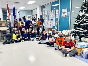 Mrs. Lawrence’s Grade 5 class at Fireside School pose with some of the donations they and their schoolmates (and particularly the students on the Leadership team) have raised for the Cochrane Activettes and their food bank. Patrick Gibson/Cochrane Times