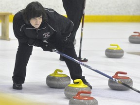 Shirley Verhoeve, president of the Mitchell Curling Club this year, leans to find the proper angle to judge a shot during recent curling action at the Mitchell & District Arena. ANDY BADER/MITCHELL ADVOCATE