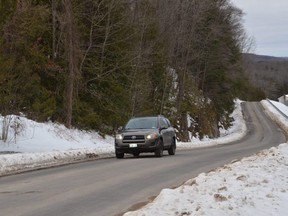 A vehicle travels along Inglis Falls Road in Georgian Bluffs on Tuesday, December 8, 2020.