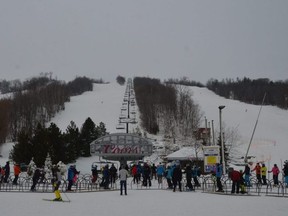 Skiers and boarders line up at the Silver Bullet chairlift on opening day at Blue Mountain Resort on Saturday, December 19, 2020.