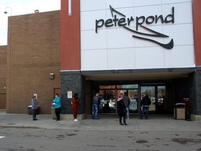 People line up outside of Peter Pond Mall in downtown Fort McMurray on Thursday, May 14, 2020. Laura Beamish/Fort McMurray Today/Postmedia Network ORG XMIT: POS2005141852523936