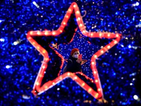 People take pictures around the Christmas decorations a few hours before the start of a two-day curfew amid the spread of the coronavirus disease (COVID-19), in Istanbul, Turkey, December 18, 2020.