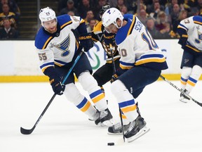 Colton Parayko #55 and Brayden Schenn #10 of the St. Louis Blues attempt to control the puck against the Boston Bruins during the first period in Game Two of the 2019 NHL Stanley Cup Final at TD Garden on May 29, 2019 in Boston, Massachusetts. Photo by Adam Glanzman/Getty Images