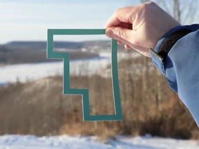 Kevin Weidlich, president and CEO of FMWBEDT, holds a #myFMWB frame over his favourite spot in the Fort McMurray Wood Buffalo region in a still from a promotional video, Supplied Image/FMWBEDT