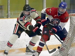 Rayside-Balfour Canadians forward Mitchell Martin (15) battles for a puck with Blind River Beavers defenceman Teegan Dumont (6)  during first-period NOJHL action at Chelmsford Arena in Chelmsford, Ontario on Thursday, December 17, 2020.