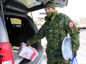 Officer Cadet Matthew Dubuc loads a few last-minute items in a vehicle for delivery Wednesday as the 2020 North Bay Santa Fund finishes dropping off Christmas hampers.
PJ Wilson/The Nugget