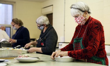Judy Chambers, left, Mary Dodman and Judy Van Horn package meals during Interfaith Caring Kitchen’s annual Christmas dinner at the Spirit & Life Centre in Chatham, Ont., on Wednesday, Dec. 2, 2020. Mark Malone/Chatham Daily News/Postmedia Network