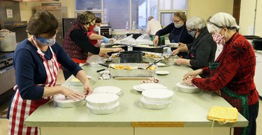 Volunteers package meals and wash dishes during Interfaith Caring Kitchen’s annual Christmas dinner at the Spirit & Life Centre in Chatham, Ont., on Wednesday, Dec. 2, 2020. Mark Malone/Chatham Daily News/Postmedia Network