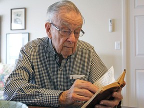 Bill Fitsell, at his home in Kingston in April 2017, reads the diary he wrote while serving in the Royal Canadian Navy during the Second World War.