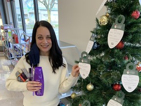 Kaylyn Van Sickle on Saturday gathered some of the items that have been donated to seniors and hung some new ornaments on the Be A Santa To A Senior Christmas tree at the Shoppers Drug Mart on Stanley Street.