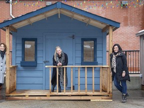 Lori Long, Ange Rivard and Martha Leach show one of 15 vendor huts set up outside 100 Kellogg Lane for a Christmas market. Other kiosks will be located inside the main building. (Derek Ruttan/The London Free Press)