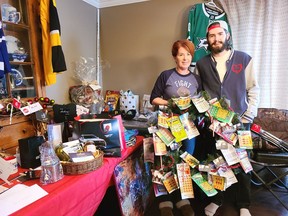 Marianne and Mike Minns, organizers of Destig's Virtual Fundraising Auction in Memory of Patrice Wren, show off some of the items up for grabs in the online auction for the event, with all proceeds going to the Robbie Dean Family Counselling Centre.