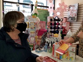 A new downtown shopping passport is explained to Betty Anderson by Rocking Horse toy store employee Jaime Balsom in Owen Sound, Ont. on Saturday, Dec. 5, 2020. (Scott Dunn/The Sun Times/Postmedia Network)