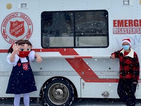 Salvation Army family services and food bank co-ordinator Alice Wannan donned the Sally Ann costume and helped served Christmas dinner from this van in partnership with Colleen Trask Seaman, right, the executive director of OSHaRE. (Supplied to The Sun Times/Postmedia Network)