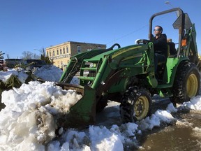 A tractor operator who didn't want to be identified removes snow from a parking lot on Wednesday December 2, 2020 in Petrolia, Ont. (Terry Bridge/Sarnia Observer)