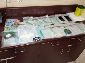 Drugs, cash and brass knuckles were seized after a vehicle was stopped on Highway 402 Thursday, Lambton OPP said. (Submitted)
