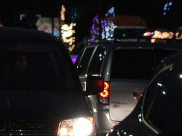 Traffic passes by displays in the drive-thru Santa Claus Parade in Sarnia Dec. 5. Lines of cars backed out onto London Road and there was bumper-to-bumper traffic for most of the parade, organizers said. (Tyler Kula/The Observer)