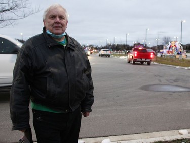 Bob Marks with the Sarnia Kinsmen Club poses at the start of the drive-thru parade Dec. 5 at Lambton College in Sarnia. (Tyler Kula/The Observer)