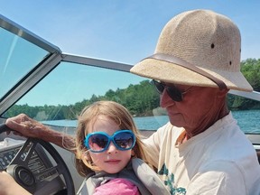 Tim Dodd enjoys a boat ride with a young member of his cottaging clan. The retiree sadly passed away after experiencing a cardiac arrest at Panache Lake.