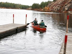 Staff at Conservation Sudbury move and anchor floating docks away from the shoreline at Lake Laurentian last fall. Municipal leaders are joining conservation authorities in their fight against legislative changes that could compromise protection of the environment.